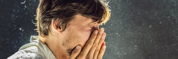 Man with allergies sneezing